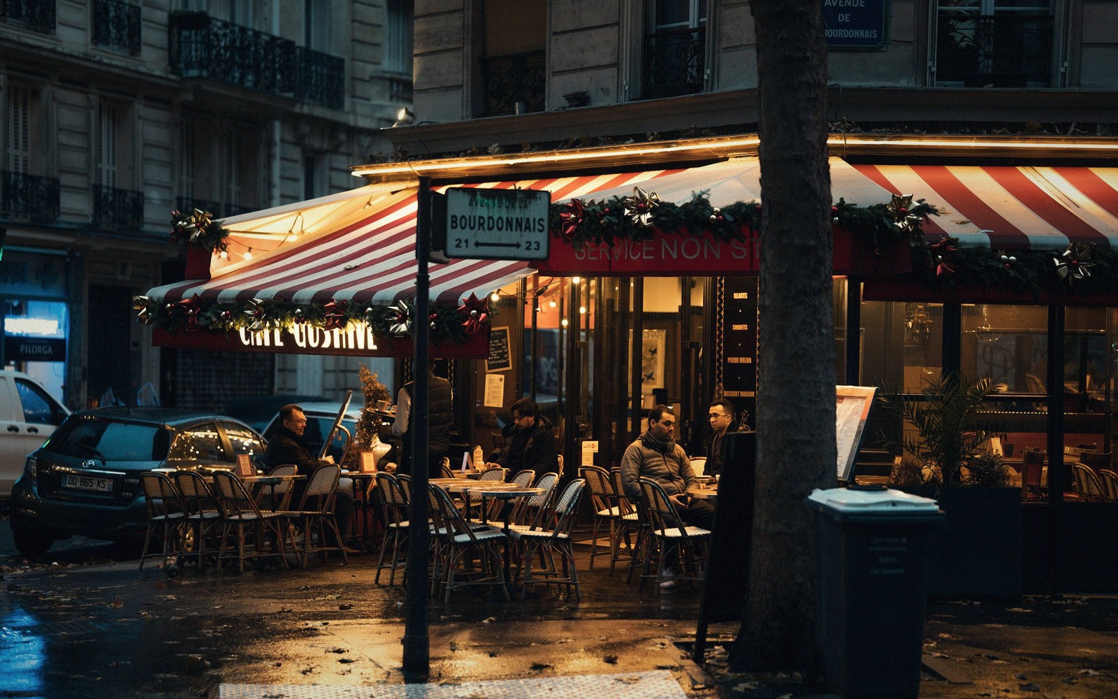 An empty Paris café terrace with bentwood chairs